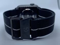 Golby Watch Straps Ltd Presents: Black with White Stripe French Marine Nationale style elasticated watch straps for Apple Watch / IWatch.  Fitting Width -  For 38mm to 40mm or 42mm to 44mm Apple IWatch Strap Colour - Black with White Stripe Strap Size - Fully adjustable to fit wrist size from 6.3 inches to 9.5 inches. The model wearing the strap has a 7.1inch wrist. Please see the sizing guide for further details. Strap - Elasticated stretch material for comfort, 22mm wide Clasp Colour - Black c Black Bracelet Strap Apple Watch Band For Everyday, Adjustable Black Watch Band, Adjustable Black Watch Band With Wrist Strap, Adjustable Black Bracelet Strap Watch Bands, Casual Black Apple Watch Band For Everyday Use, Black Adjustable Wrist Strap Watch Accessories, Black Adjustable Wrist Strap For Watch, Adjustable Black Wrist Strap Watch Accessories, Casual Black Adjustable Watch Band