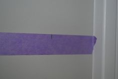 a purple tape is taped to the wall