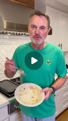 a man holding a white plate with food on it