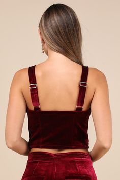 Keep things sultry-chic all night long in the Blank NYC Sneak Peak Burgundy Velvet Bustier Crop Top! Soft, plush velvet shapes this party-ready top with wide adjustable straps and a sweetheart neckline. Fitted, bustier-inspired bodice features seamed cups and flattering stitching before ending at an ultra-cropped hem. Hidden side zipper. Pair with the matching pants for a complete look! Fit: This garment fits true to size. Length: Size medium measures 9.75" from adjustable straps to hem. Bust: Works best for A to C cup sizes - consider sizing up for fuller bust. Waist: Fitted - very fitted at natural waist. Undergarments: May be worn with a strapless bra, adhesive bra, petals, or no bra. Fabric: Fabric has no stretch. Lined. Shell: 95% Polyester, 5% Spandex. Lining: 97% Polyester, 3% Spand Party Cropped Corset With Boned Bodice, Cropped Party Corset With Boned Bodice, Party Crop Top With Boned Bodice, Cropped Evening Corset With Corset Back, Cropped Corset With Corset Back For Evening, Velvet Party Corset, Elegant Crop Top With Corset Back For Party, Elegant Party Crop Top With Corset Back, Elegant Cropped Corset For Parties