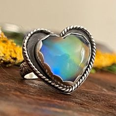 Size 8.5 - Aurora Opal heart set in scallop bezel with shadow box heart back plate.  Floral paisley band in size 8.5 (can not be resized). By purchasing this ring you are conforming you've read the item description, and agree to my shop policies.  This ring can not be resized, so please be sure of your ring size before purchasing. Aurora Opal, Back Plate, Shop Policies, Rings Statement, Shadow Box, Statement Rings, Aurora, Beauty Book, Paisley