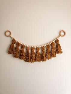 the tassels and beads are hanging on the wall