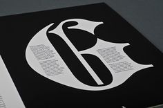 an open book with black and white designs on the front cover, featuring a letter f