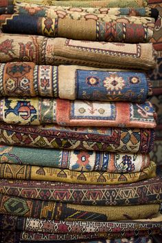 a pile of rugs stacked on top of each other