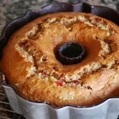 a bundt cake sitting on top of a metal pan next to a cooling rack