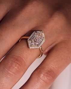 a woman's hand with a diamond ring on it