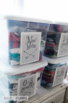 two plastic bins with labels on them sitting on a shelf next to each other