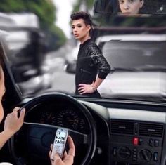 the woman is using her cell phone while driving