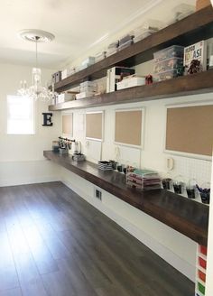 an empty room with wooden floors and shelves