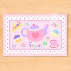 a pink placemat with a teapot and cupcakes on it that says teagan