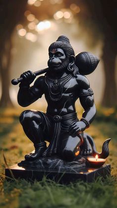 a statue of a hindu god sitting on the ground