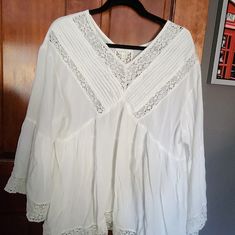 This Beautiful Flowing Beauty Is Chic And Charming. It Is A Perfect Addition To Your Wardrobe With A Sweater In Cold Months Or Just As For Summer! Flowy Cotton Tops With Lace Trim, Cotton V-neck Blouse With Lace Top, Cotton Lace Top V-neck Blouse, Flowy Long Sleeve Top With Lace Trim, Long Sleeve Tops With Lace Trim For Vacation, Chic Flowy Tops With Lace Trim, Flowy Blouse With Lace Trim For Brunch, Flowy Tunic Tops For Daywear, Long Sleeve Tops With Lace Trim For Day Out