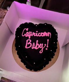 a heart shaped cake in a box with the words capricon baby written on it