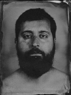 an old black and white photo of a man with a beard