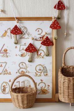 a wall hanging with numbers and mushrooms on it