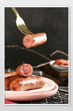 there is a fork with some sausages on it and the plate has one piece taken out