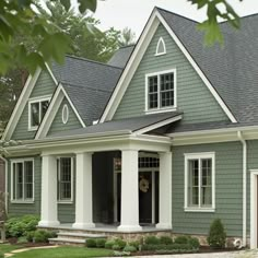 a house with green siding and white trim