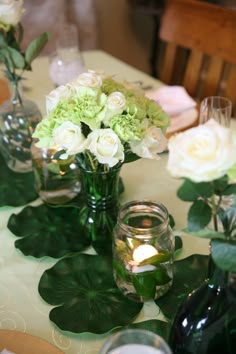 there are many vases with flowers on the table