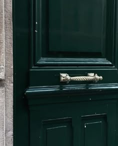 a green door with a rope on it