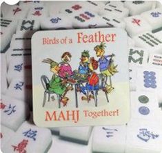 a group of white dices with the words birds of a featherer and mahj together