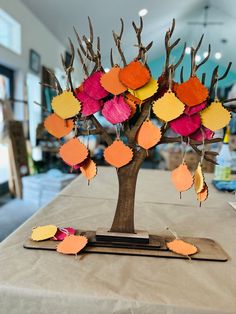 a tree that has been decorated with different colored leaves