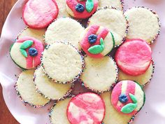 a white plate topped with cupcakes covered in frosting