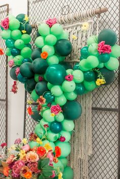 a bunch of balloons that have flowers on them