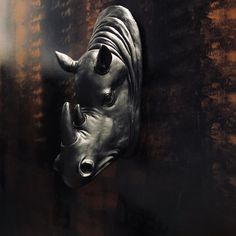 a rhino head mounted to the side of a wall