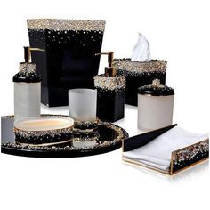 black and white bathroom accessories with gold accents