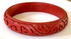 Antique Asian Cinnabar bangle bracelet with stone in carving and layered lacquer visible with magnification showing the difference between old hand made and later plastic examples. 3" W x 1/2" H Traditional Carved Round Bangle, Traditional Carved Bangle, Traditional Round Carved Bangle, Carved Bangle Bracelets, Traditional Carved Bangle Bracelet, Bangle Bracelets, Jewelry Bracelets, Bangles, Bracelet