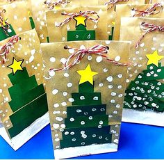 small brown bags decorated with christmas trees and stars