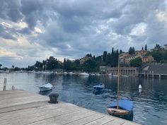 boats are docked on the water near a dock