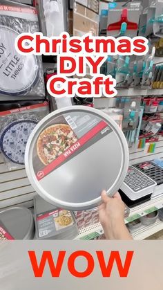 a person holding a pizza pan in front of a store display with the words christmas diy craft on it