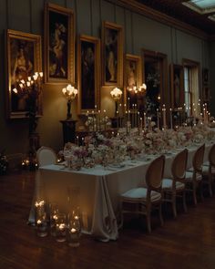 a long table is set up with candles and flowers for a formal dinner or party