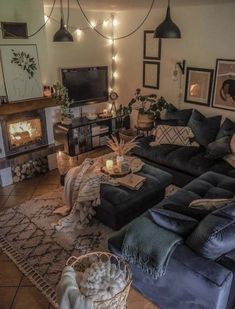 a living room filled with furniture and a fire place next to a wall mounted tv