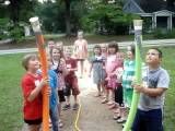 a group of young children standing around each other