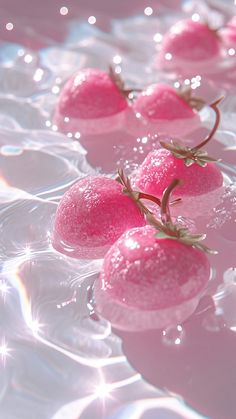 some pink strawberries floating on top of water