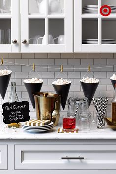 a kitchen counter topped with lots of bottles and glasses