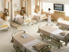 a hospital room filled with lots of beds