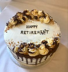 a birthday cake with the words happy retirement written in frosting and chocolate sprinkles