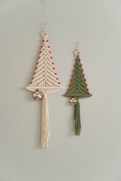 two christmas tree ornaments hanging on the wall