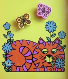 there are two buttons that look like cats and butterflies on the yellow background with blue flowers