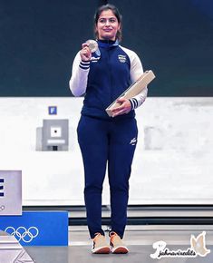 a woman standing on top of a stage holding a piece of paper in her hand