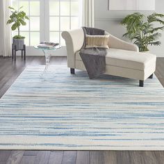 a white and blue rug in a living room