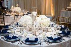 the table is set with blue and white place settings