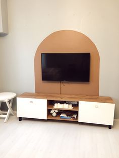 a flat screen tv sitting on top of a wooden entertainment center