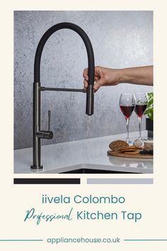 a kitchen faucet with wine glasses on the counter and in front of it