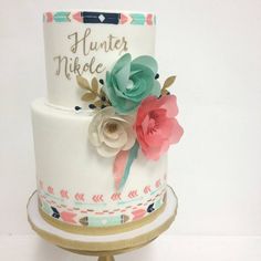 a three tiered cake decorated with flowers and the words hunter, hike on it