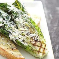 a white plate topped with bread and veggies covered in parmesan cheese