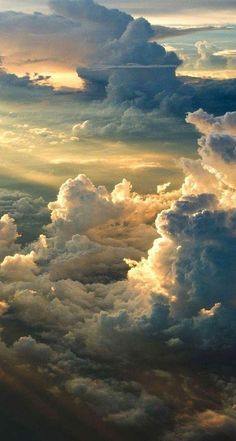 the view from an airplane looking down at clouds